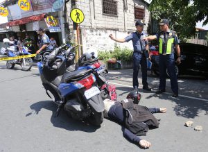 MAY KINALAMAN SA TRABAHO? Iniimbestigahan ng mga pulis ang pagkamatay ng kanilang kabaro, si Staff Sergeant Fernando Diamzon, 49, ng Intelligence Group ng Philippine National Police (PNP), makaraang tambangan ng riding-in-tandem sa Bgy. Bagong Lipunan sa Quezon City, ngayong Biyernes. (ALI VICOY)